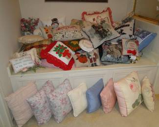 Fun and colorful decorative pillows, all piled high in a Jacuzzi Tub