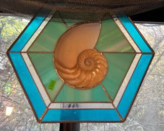 Stain glass with a real shell in the center