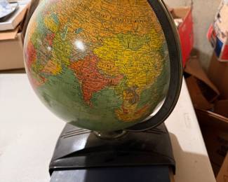 Vintage globe w/stored  atlas 