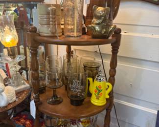 tiered shelf with lots of collectible glasses