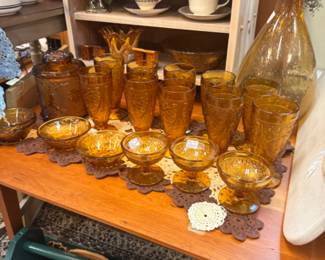 amber glassware, tea cups and saucers, large amber colored botle
