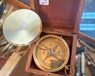 Small nautical-themed wooden box with compass inside with brass anchor inlay on lid 