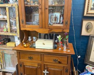 maple hutch with a glass door and cupboard doors