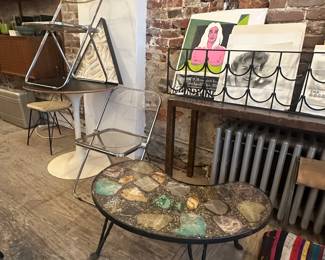Italian folding chairs mid-century table with black top amoeba shaped resin and stone table and art