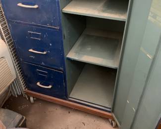 #42	blue metal cabinet with 3 drawer file and door with 2 shelves  on wheels 30x18x38	 $100.00 
