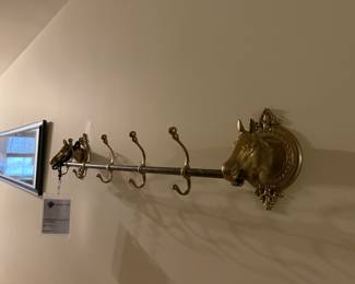 Brass horse head wall mounted coat rack.