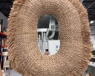 Made Goods Casey Fringe Oval Mirror in Natural Braided Raffia. Measures 42" W x 52" H x 2" D. 