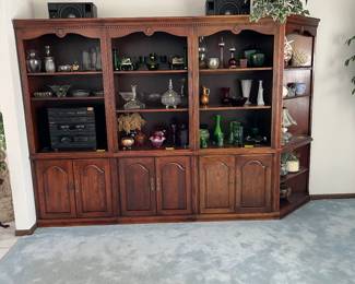 Like new bookcase unit with glass ware, decorative objects