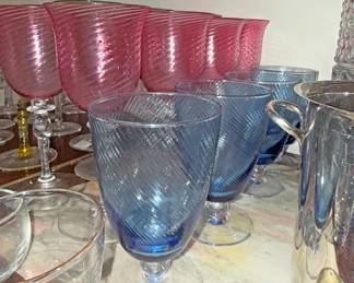 Footed water or wine goblets made of optic glass with a distinctive swirl or twist pattern