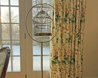Vintage metal floor birdcage on a stand