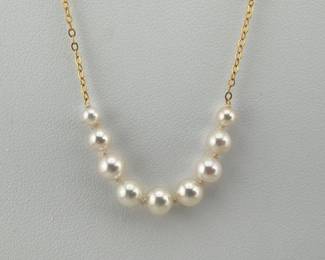 Graduated freshwater pearl necklace is on 14kt gold chain; 17"L