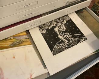 Drawer full of various large paintings