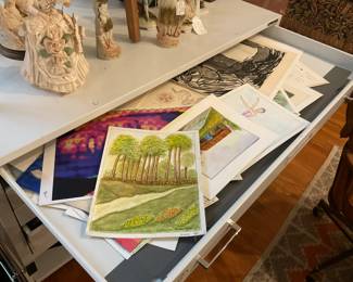 Drawer full of various small paintings