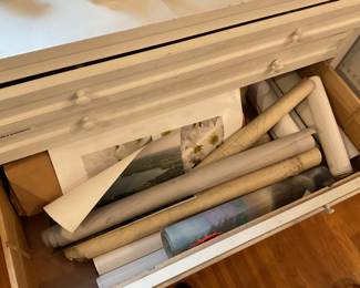 Drawer full of various large artwork