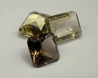 Three Loose Emerald Cut Gemstones Including Smoky Quartz