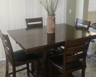 Expanding table with chairs.  Leaf pulls out of table