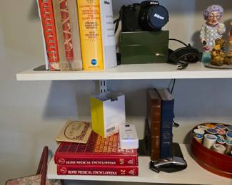 Nikon camera, Thread, Granny statue, Sewing basket with handle, cook books