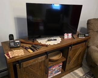 Tv, Entertainment center with rolling doors, Rocking chair, phone