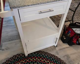 Kitchen Island white with gray stone top and side towel bar and cabinet