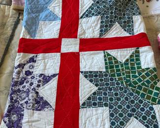 Hand pieced, hand quilted Texas star quilt set together with red and white. 