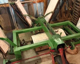 vintage agricultural equipment, specifically what appears to be a mower designed for cutting grass or hay.