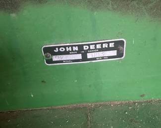 John Deere 127 rotary mower, also referred to as a gyro mower.  It is designed for cutting brush, weeds, and tall grass.  The mower features a durable metal deck and is designed to attach to a tractor.  These mowers are typically used for clearing pastures and maintaining roadsides. 