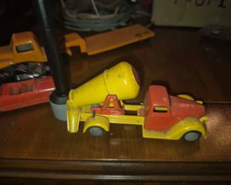 vintage diecast toy is a Tekno Denmark No. 422 Ford V8 cement truck, featuring a red cab and yellow mixer drum. Produced in Denmark during the 1940s and 1950s