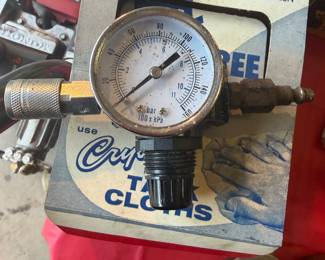 pneumatic air pressure regulator with a gauge, often used for spray guns or air tools. 
