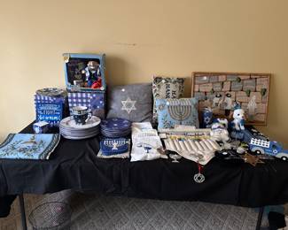 Hanukkah decorations including dishes, mugs , runner pillows, and hand made wall art