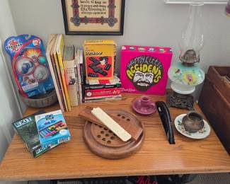 vintage games & books, side table made of antique sewing machine treadle base, antique kerosene lamp