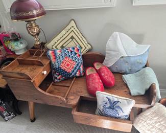 Vintage primitive cobbler's bench end table, vintage Dutch wooden shoes and lady's cap, handmade needlepoint throw pillows