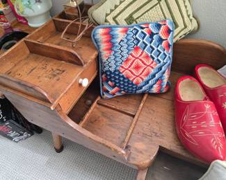 Vintage primitive cobbler's bench end table, vintage Dutch wooden shoes and lady's cap, handmade needlepoint throw pillows