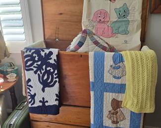 Primitive blanket chest with old quilts; vintage hard side luggage