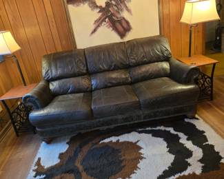 Huge RYA rug, brown leather sofa, pair of lamps w/ side tables built-in
