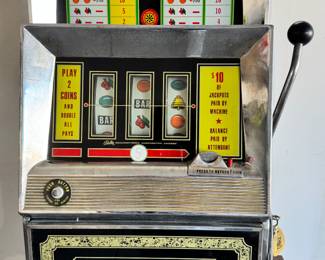 Antique Bally's Nickel Slot Machine.  Has key and opens for access.   Lights (no sound), slot for nickels, arm mechanism, and release of coins all work.  Plug damaged.
