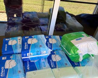 Many, many packages of disposable underwear and bed pads. Priced way below store! All unopened! 