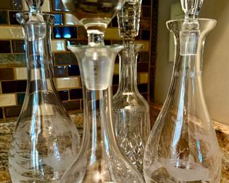 Old engraved crystal decanters featuring hunt scenes