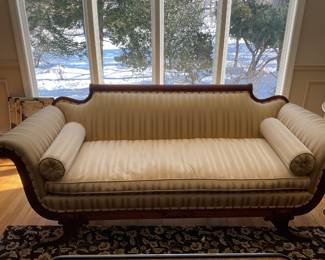 Antique sofa with roll pillows.