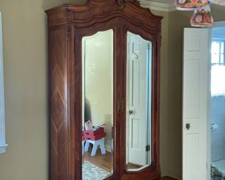 Large antique double door armoire with mirrors.