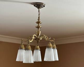 Vintage brass chandelier with glass shades.