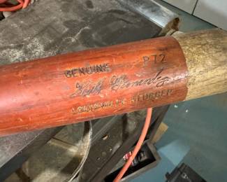Vintage Louisville Slugger wooden baseball bat, Model 126, natural finish with red handle. Visible age wear consistent with use and storage. Approx. Dimensions: 34–35 inches long