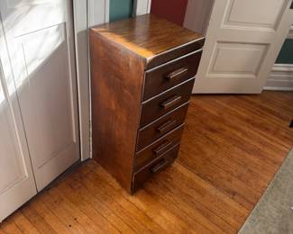 Lingerie Chest / Slim Tallboy Dresser Circa 1950’s - 1960’s, slim, vertical design, Birch or Maple with a dark walnut-toned stain, Approx. Height 36" – 42" Width14" – 18" Depth12" – 16" Hardware Sculpted wooden bar pulls (integral to the drawer fronts) Condition: Good vintage condition with light surface wear on the front. Price: $85