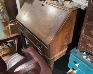 Mid century slant drop-front desk, Pine or Maple with a dark fruitwood or walnut stain, Approx. Height 38" – 42" Width28" – 32" (Compact/Apartment size )Depth16" – 18" (Closed) Hardware Brass, Condition: Sturdy vintage wood with small surface wear Price: $150