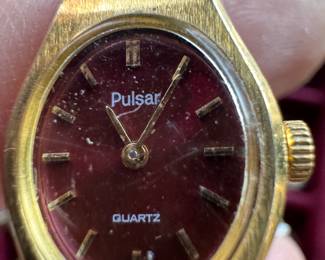 Vintage Pulsar quartz wristwatch, Gold-tone case, burgundy/maroon dial, some visible scratches and normal wear, $300