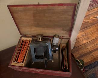 Victorian-era magic lantern / lantern slide projector housed in a red wooden case, 19th–early 20th century, Untested, $390