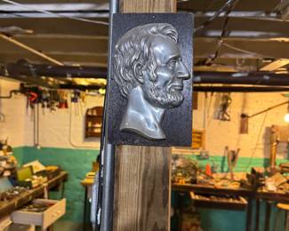 Cast metal Abraham Lincoln profile relief plaque mounted on a rectangular backing, Price: $60