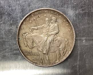 1925 STONE MOUNTAIN HALF DOLLAR DESIGNED BY GUTZON BORGLUM. THE 1925 STONE MT. HALF DOLLAR WAS STRUCK TO RAISE FUNDS FOR THE COMPLETION OF THE MONUMENT IN STONE MOUNTAIN, GEORGIA