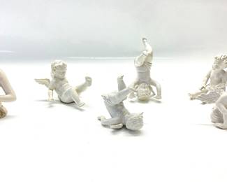 ANTIQUE PORCELAIN HALF DOLL MARIE ANTOINETTE AND A SET OF 5 PLAYFUL PORCELAIN CHERUB FIGURINES FROM THE EARLY 1900â€™s