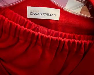 Dana Buchman vibrant red garment set top and skirt |  high-end tailoring and luxurious fabrics, this piece features a vibrant "power red" hue in a refined knit or crepe texture. | $180