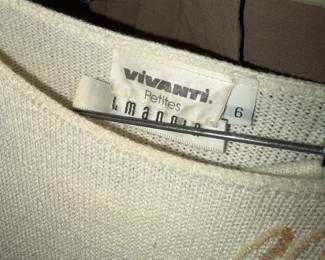 This elegant Petite size 6 sweater is crafted from a soft, fine-gauge knit in a classic cream or off-white hue. The garment features a sophisticated boat neckline and is beautifully accented with delicate, hand-applied sequin and embroidery details |  $50